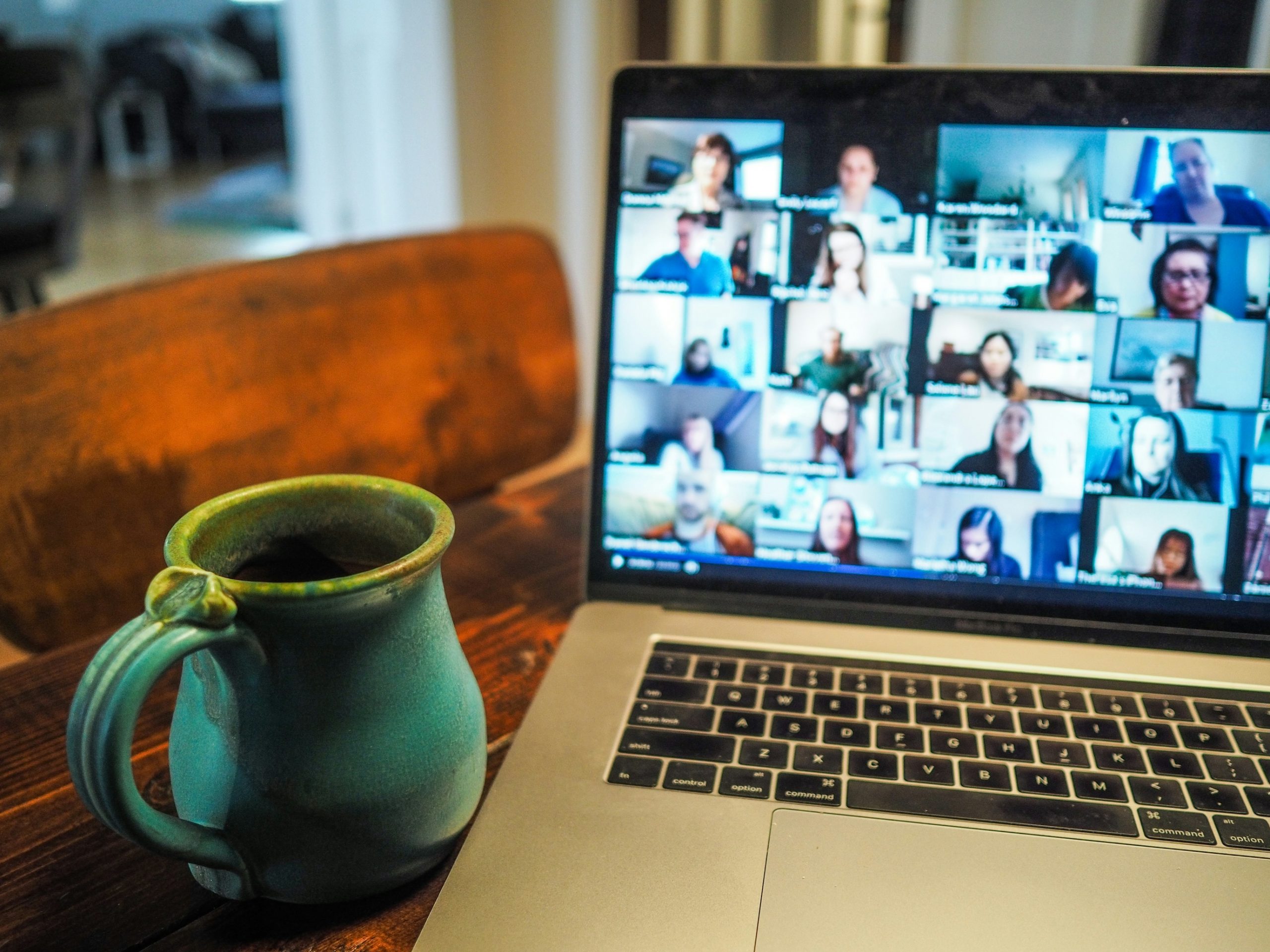 a flexible working scene of a laptop showing a zoom call