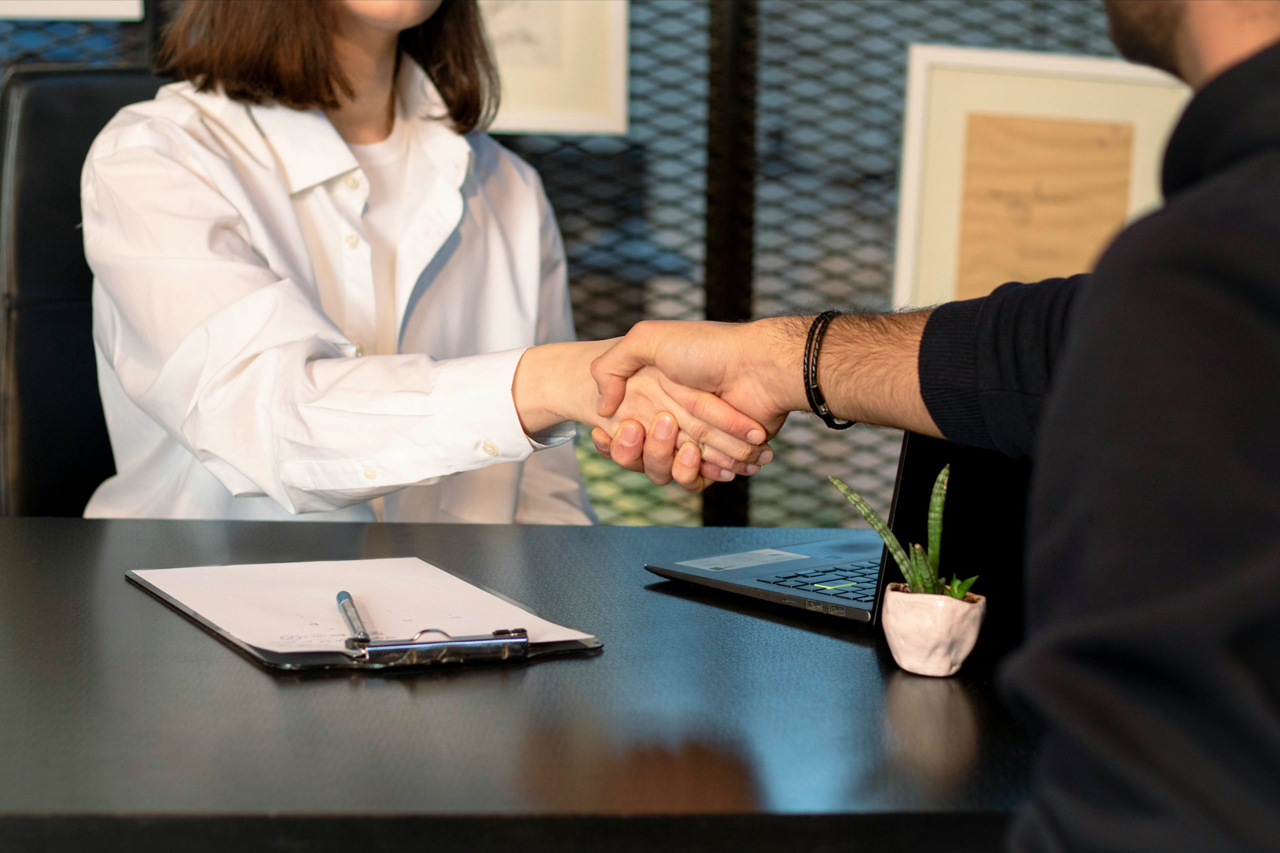 a handshake between two people after a job interview